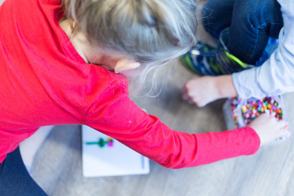 Child doing crafts at a preschool table
