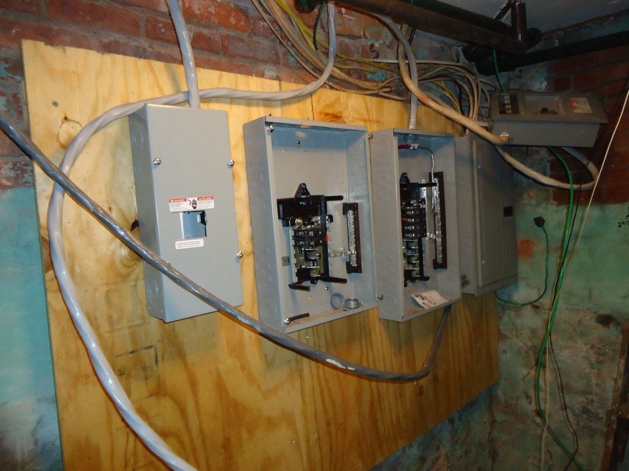 An electrical panel with wiring exposed during work
