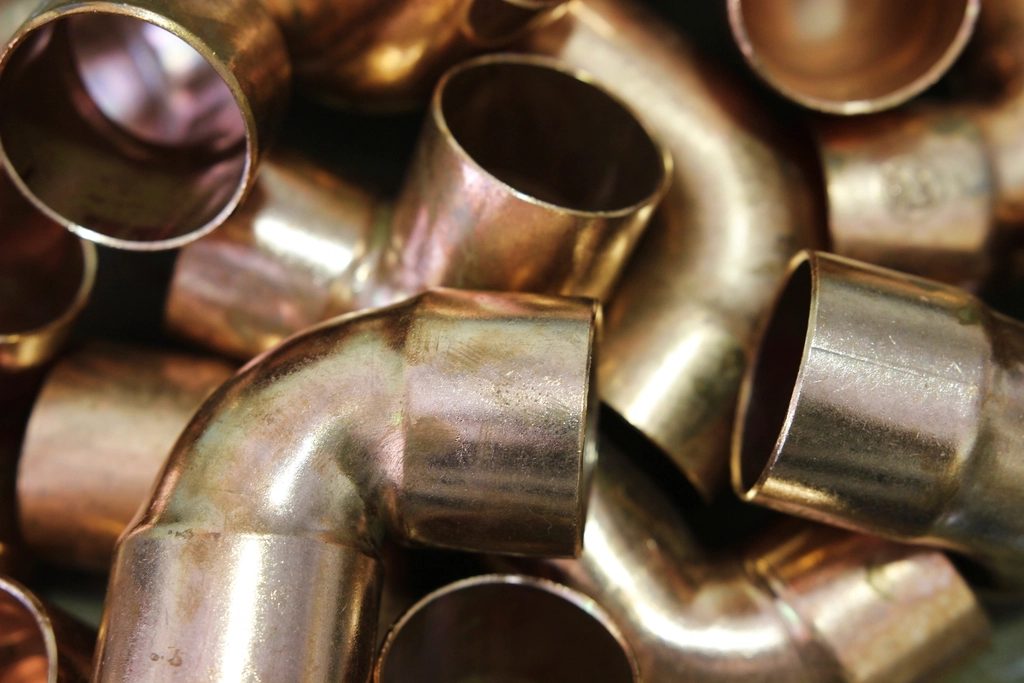 Copper pipe fittings being soldered
