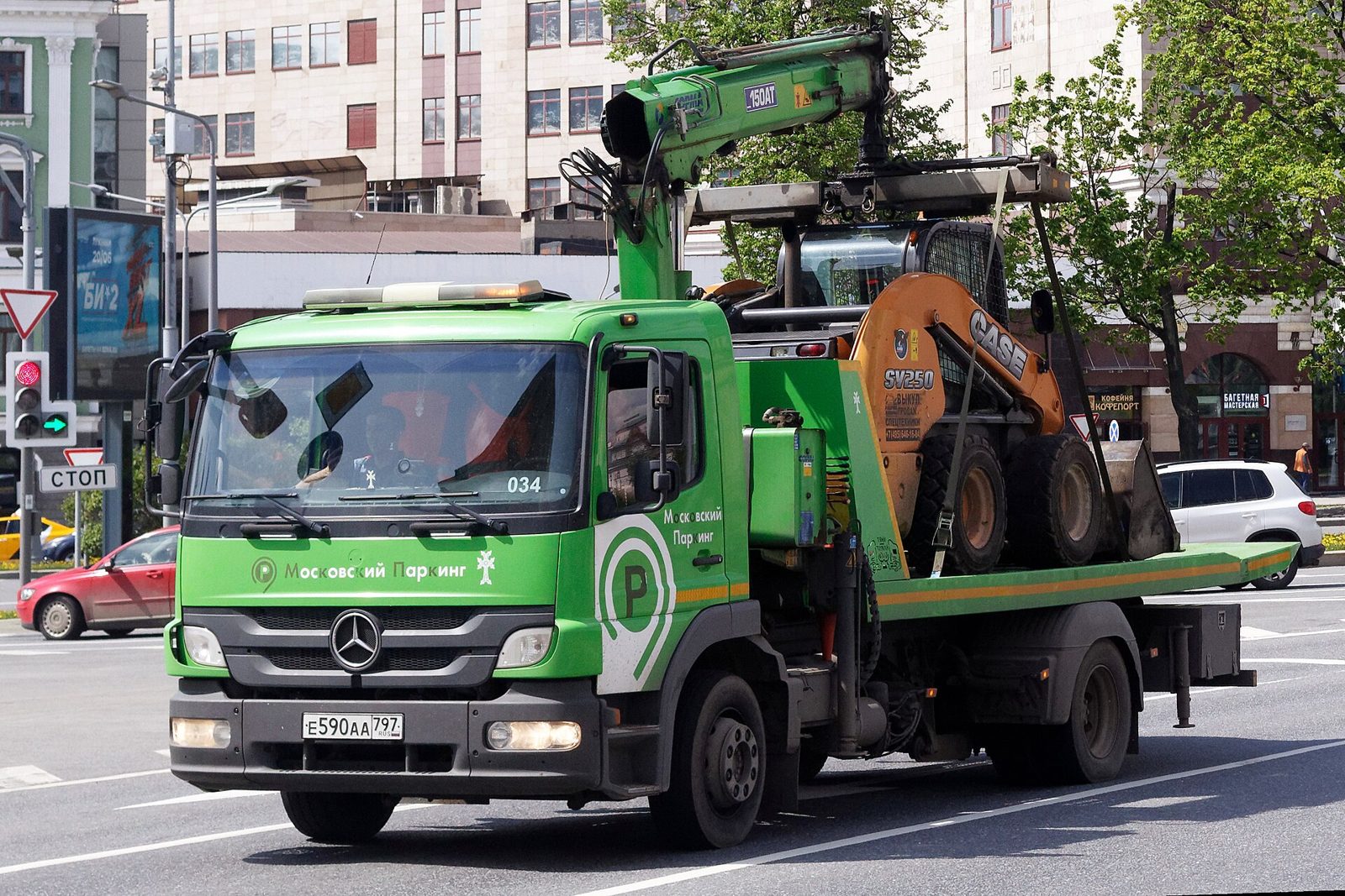 Tow truck driving through a city street